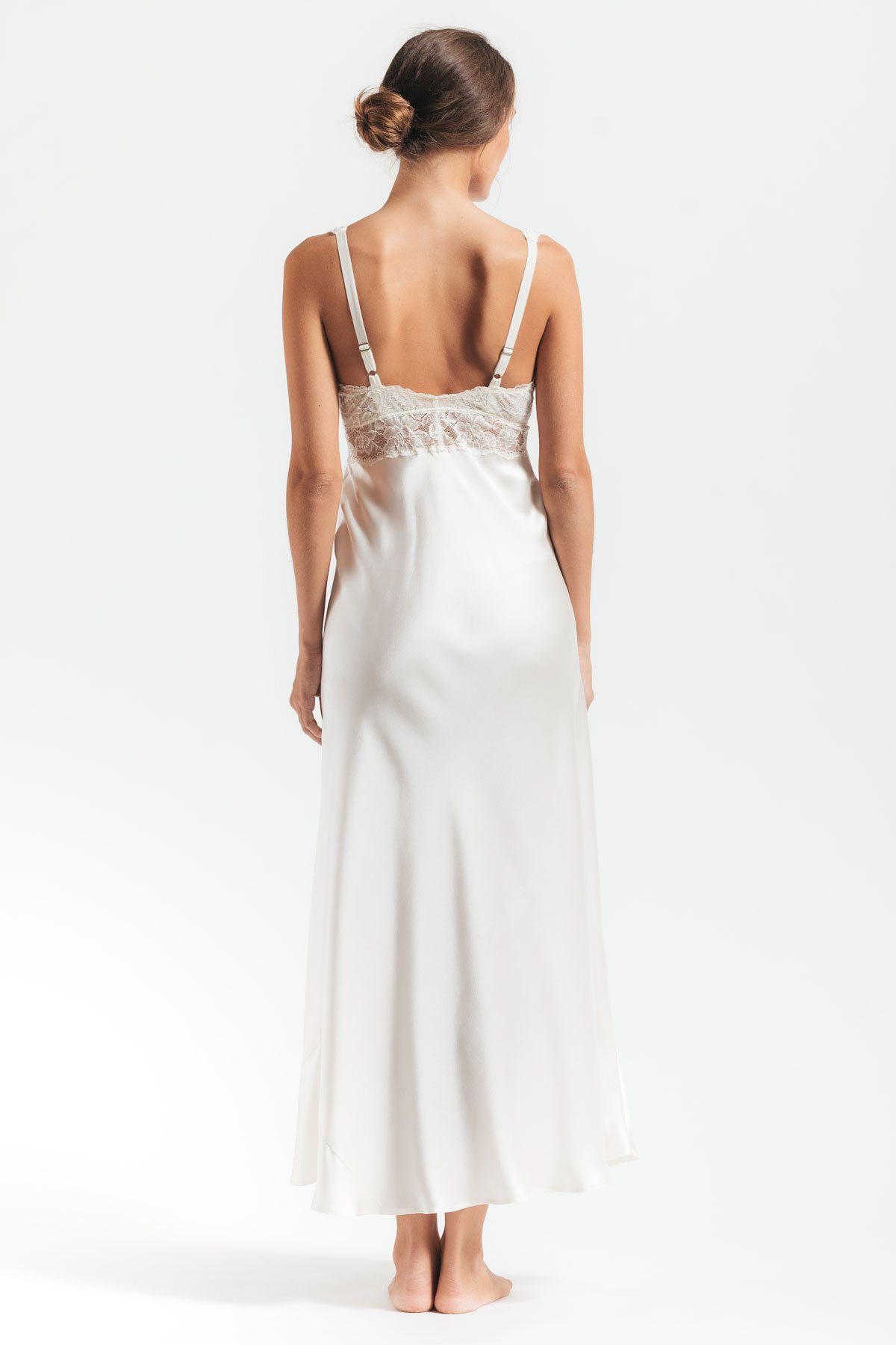 Back profile of model wearing Morgan iconic Bust-support white silk gown in Ivory