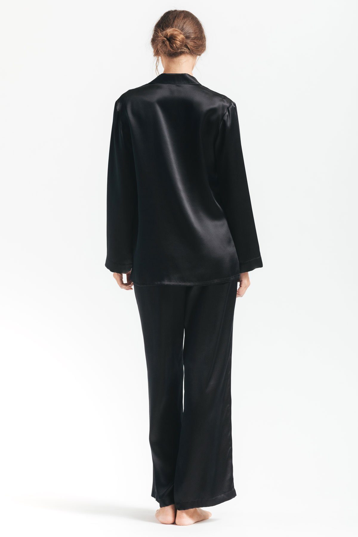 Backview of model wearing Morgan womens silk pajama set in black