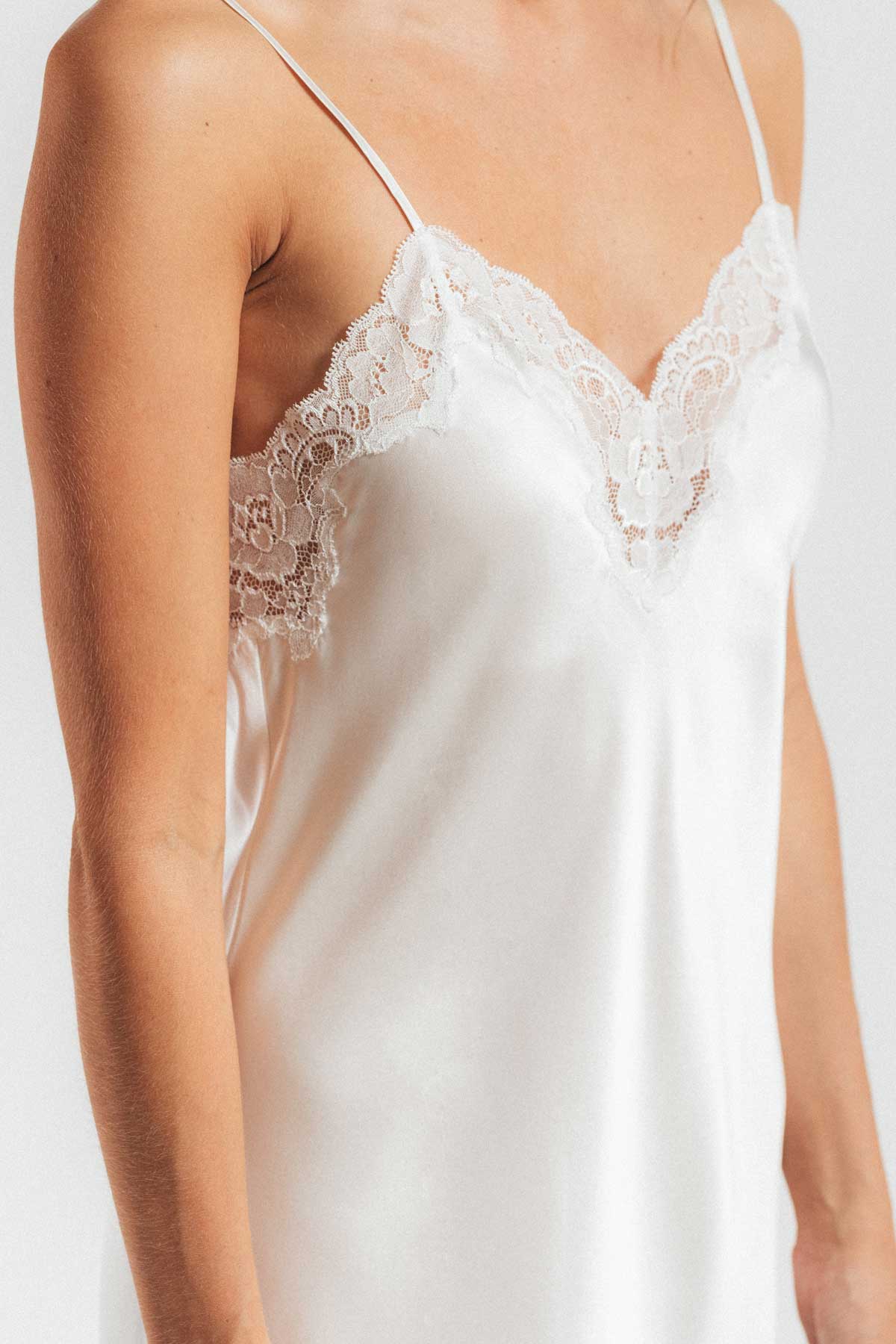 Close up of front of model wearing Morgan lace sphaghetti women's silk camisole in ivory