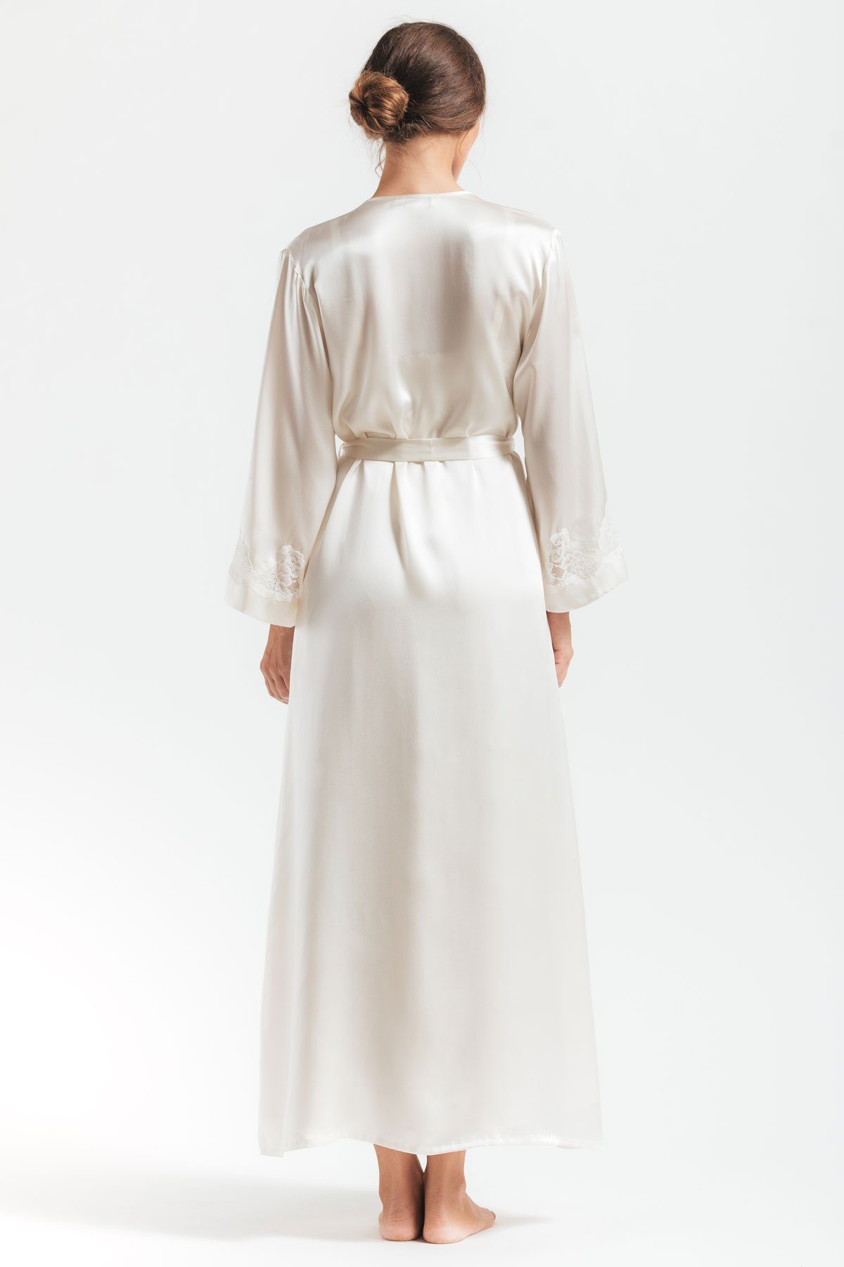 Back profile of model wearing Morgan Long white silk robe in ivory