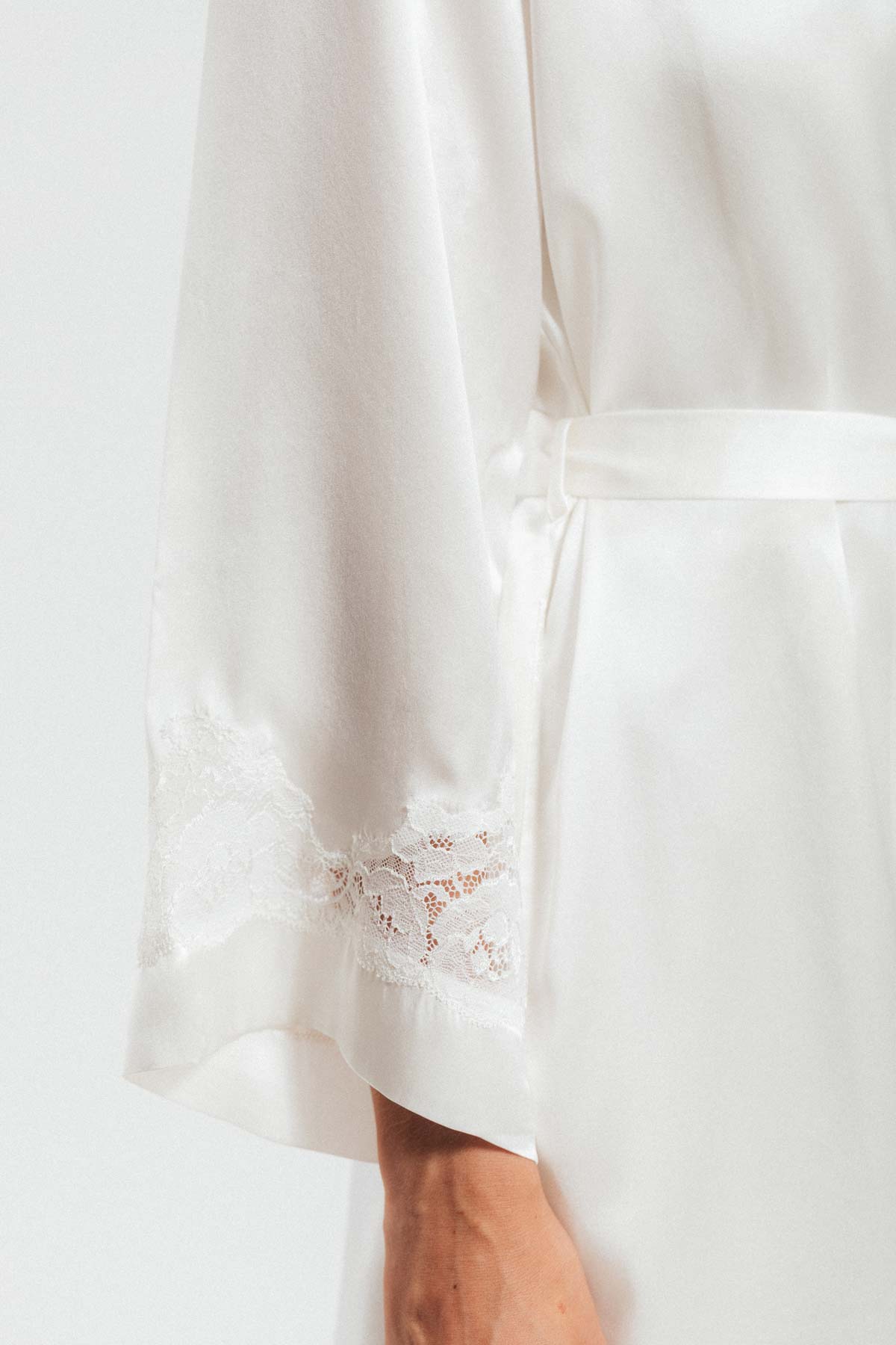 Close up of lace sleeve on Morgan Long white silk robe in ivory