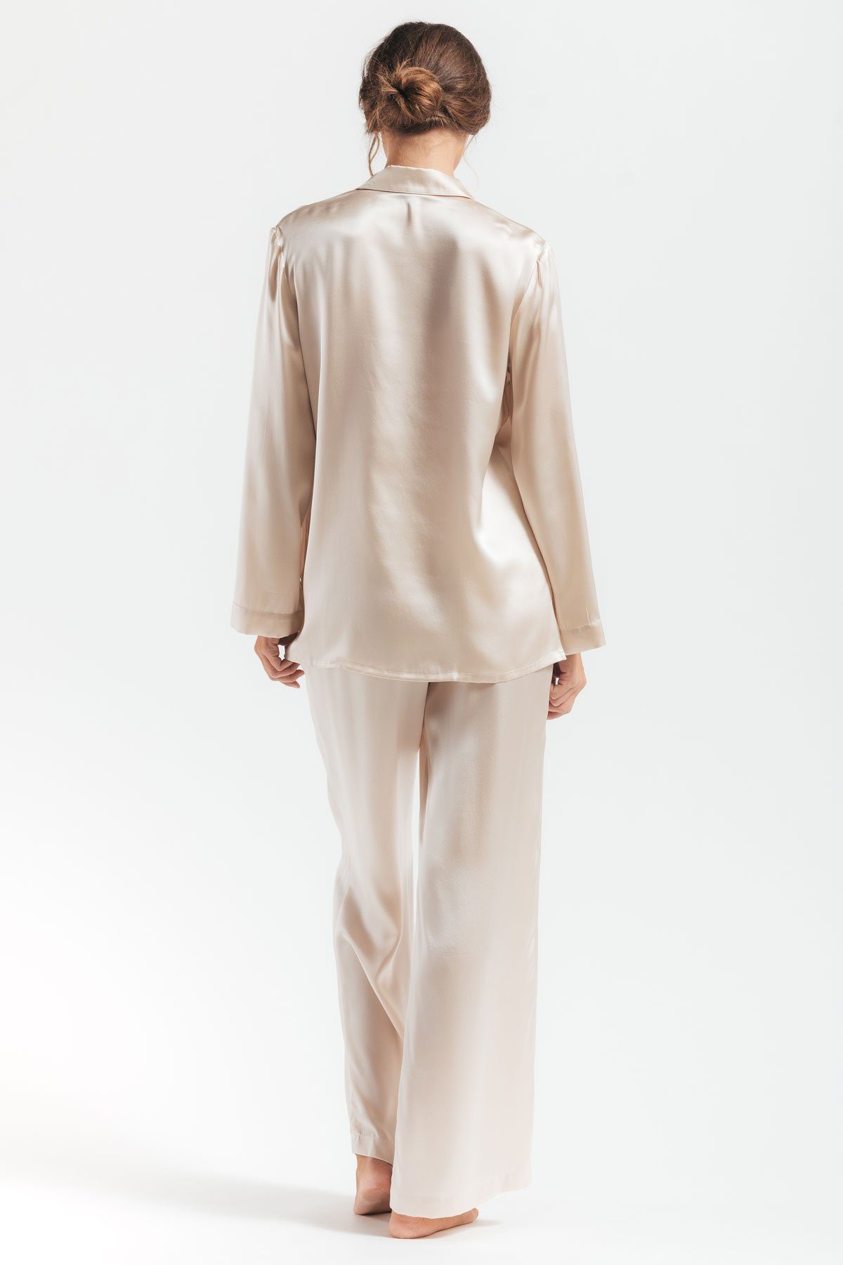 Backview of model wearing Morgan Silk pajama set in champagne