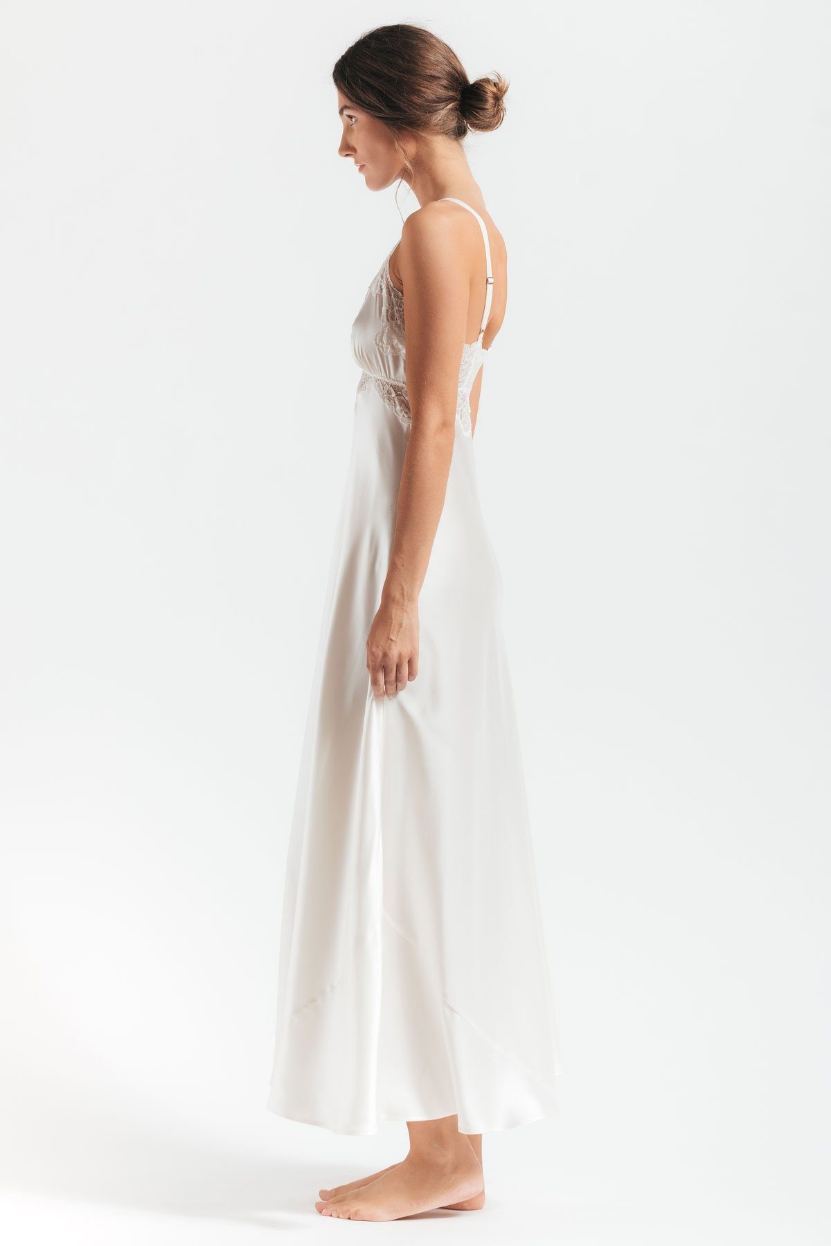 Sideview of model wearing Morgan vintage long silk sleeping gown in ivory